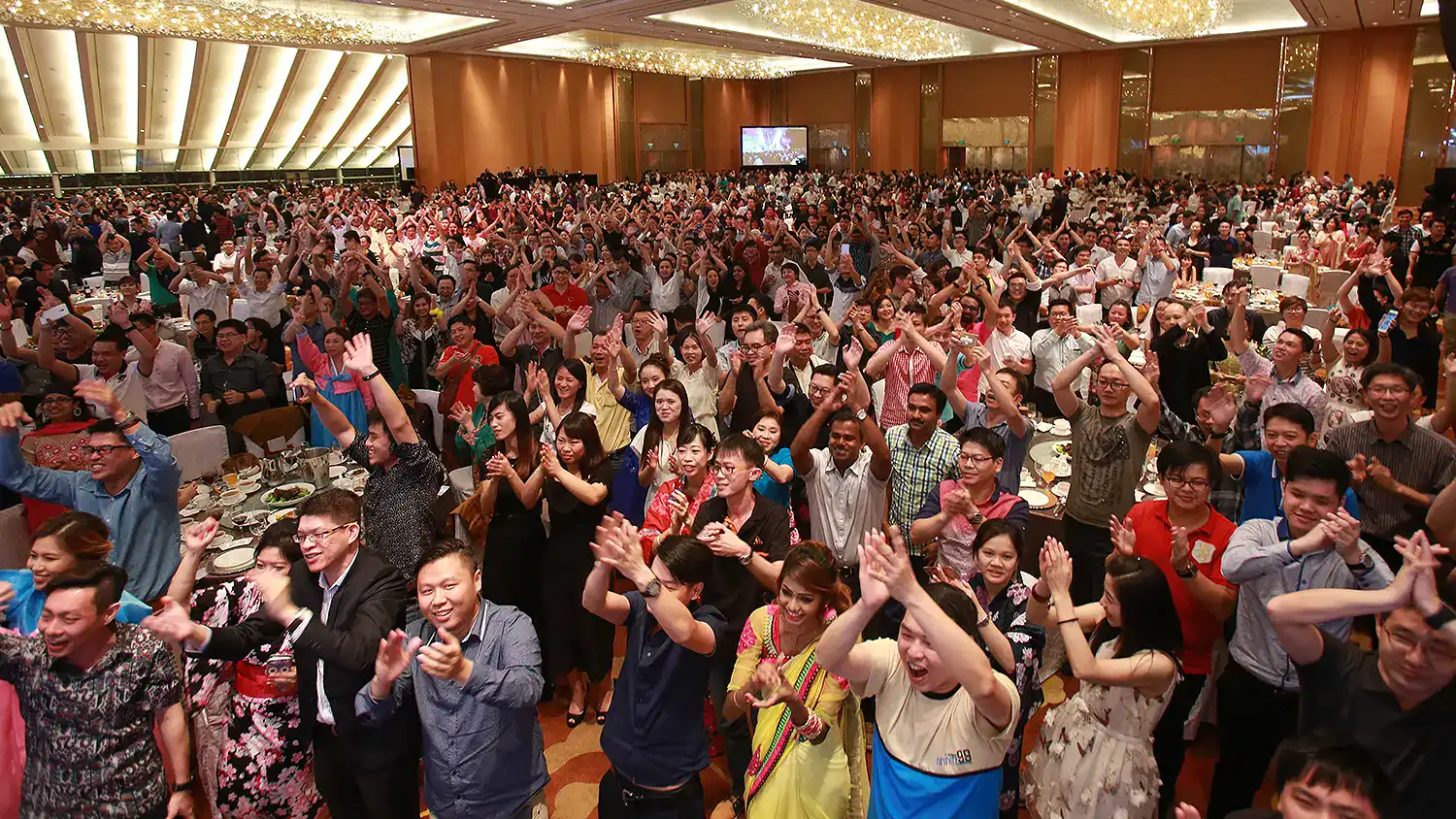 Crowd of professionals participating in a dinner and dance event by The Project Crew Singapore.